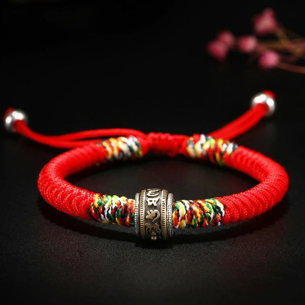 Tibetan Mantra Bracelet – Red cord with antique brass mantra bead and five-color accents, woven bracelet