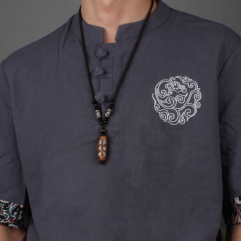Dzi Bead Necklace – Brown agate mantra pendant on black cord paired with embroidered mandarin collar, serene