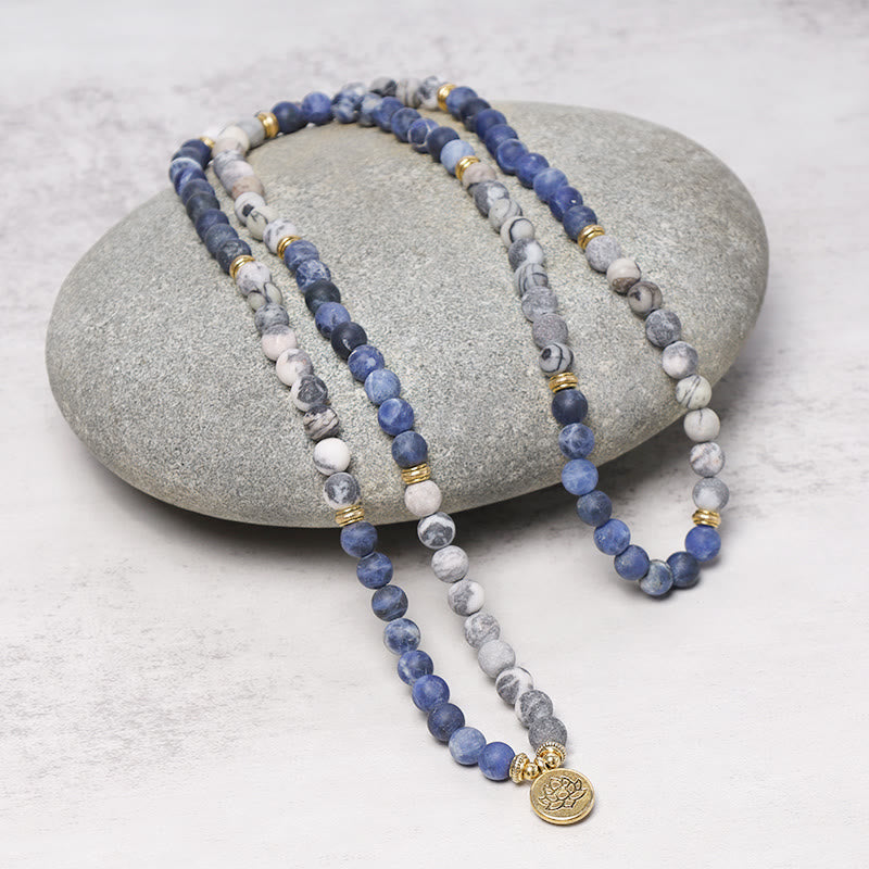 Picasso Jasper Mala – dual-strand blue white mala on gray stone with lotus, jasper