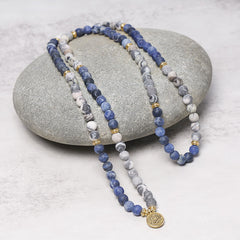 Picasso Jasper Mala – dual-strand blue white mala on gray stone with lotus, jasper