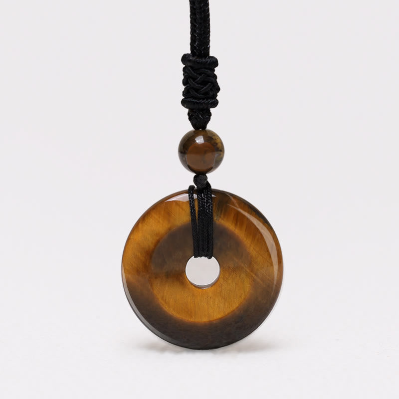 Lucky Coin Pendant Healing Crystal Gemstone Necklace – Golden-brown tiger's eye donut pendant with chatoyant bands on black cord
