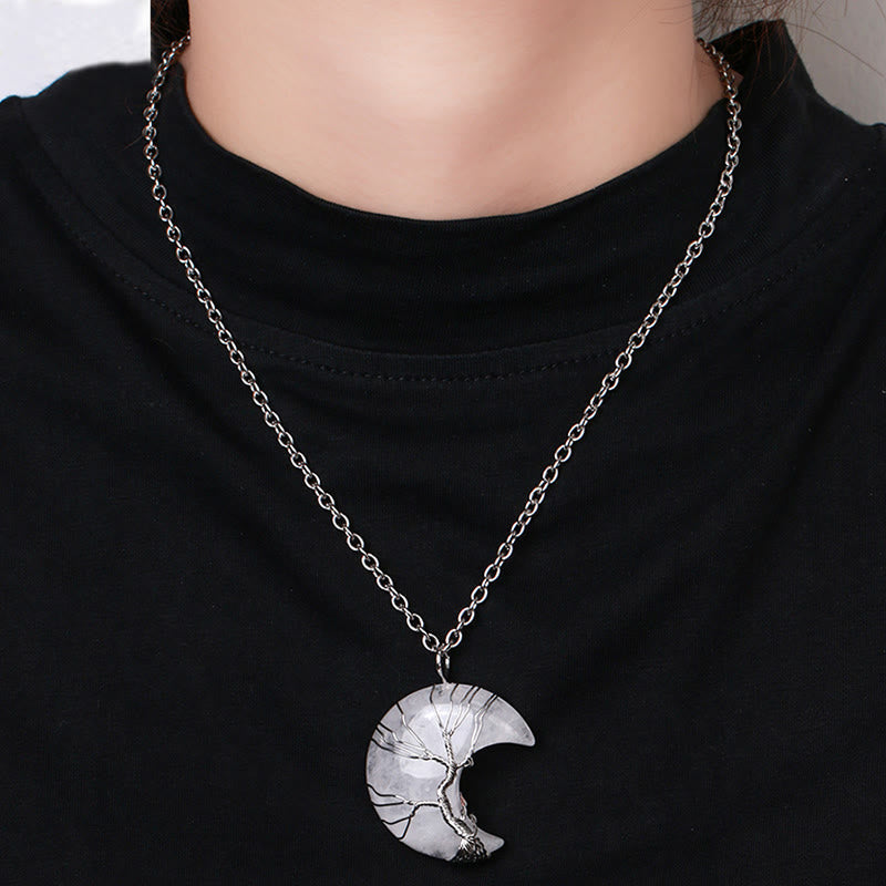 Quartz Crystal Moon Tree of Life Pendant – clear quartz moon pendant worn on model against black top, lifestyle view