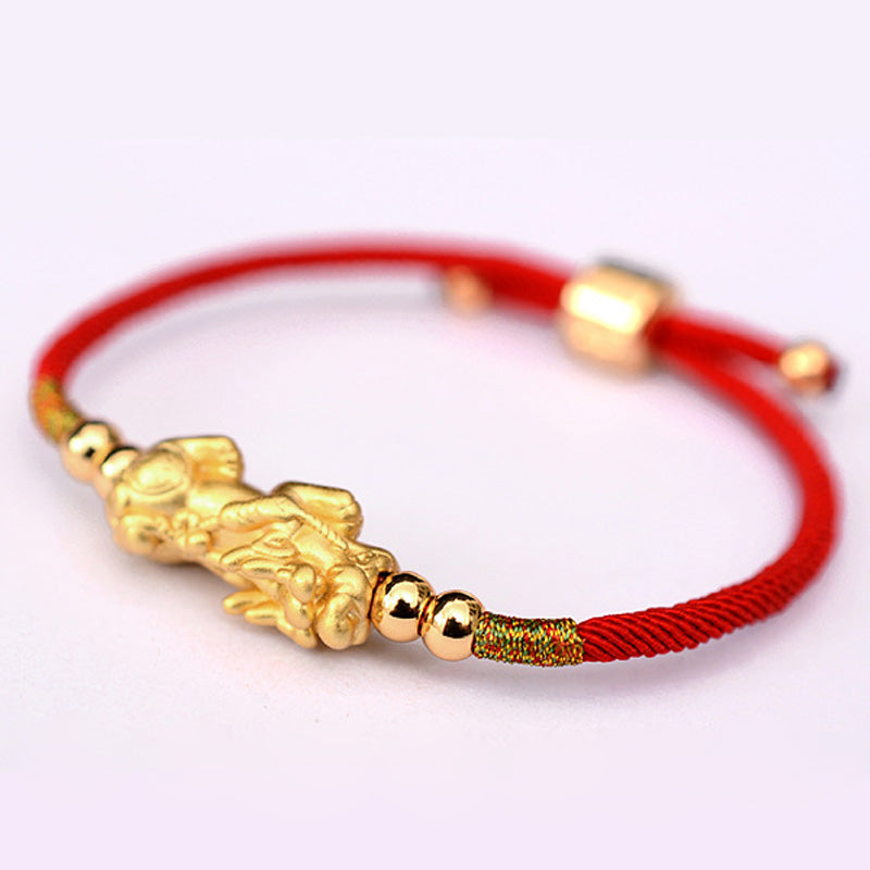 Gold-Plated PiXiu Red String Bracelet – gold PiXiu red cord bracelet on white background, wealth luck jewelry