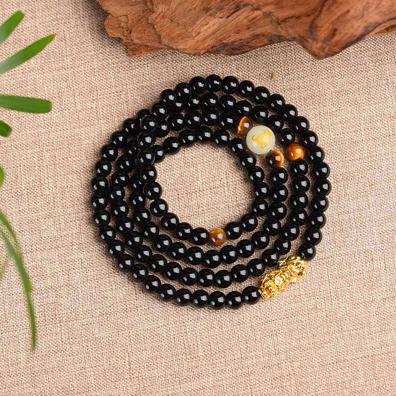 Zodiac Obsidian PiXiu Mala – Coiled black bracelet with PiXiu, glow bead top view