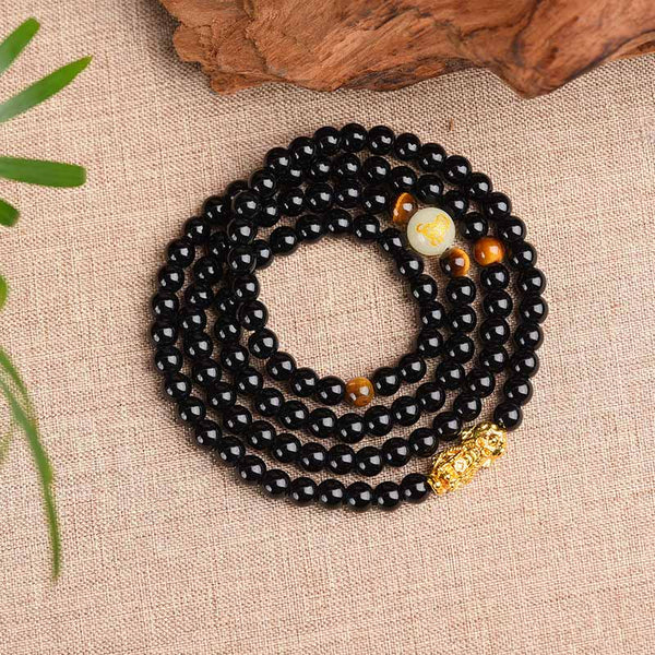 Zodiac Obsidian PiXiu Mala – Coiled black bracelet with PiXiu, glow bead top view