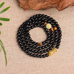 Zodiac Obsidian PiXiu Mala – Coiled black bracelet with PiXiu, glow bead top view