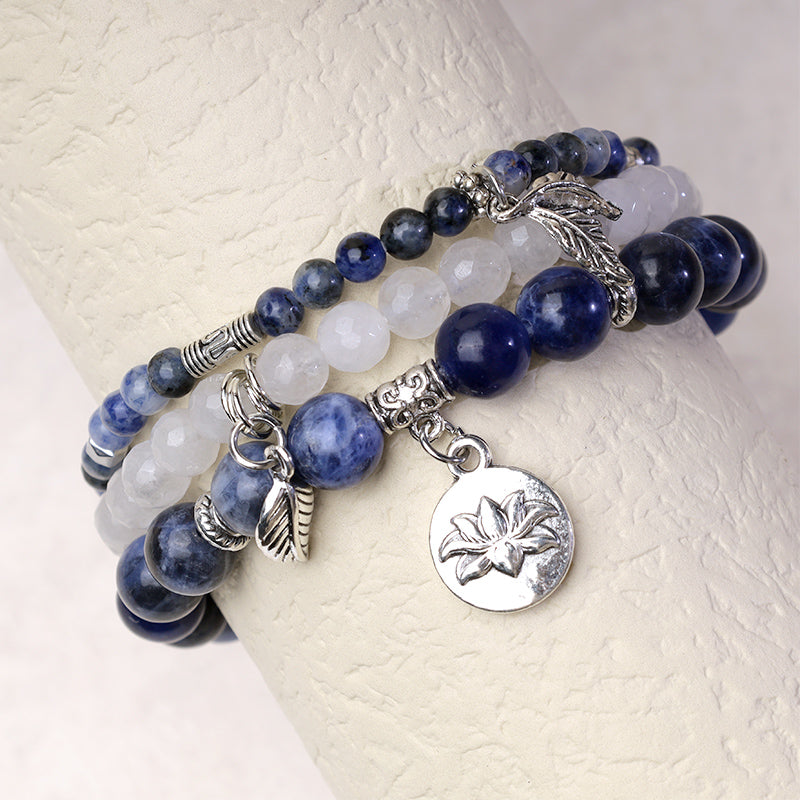 Crystal Lotus Bracelet – blue sodalite and clear quartz on wrist display with silver lotus flower pendant, boho bracelet