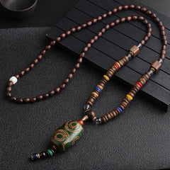 Turquoise Dzi Bead Prayer Wheel Wenge Wood Necklace - Long beaded necklace with green dzi bead barrel pendant, three eye patterns, color-blocked accent beads, and tassel