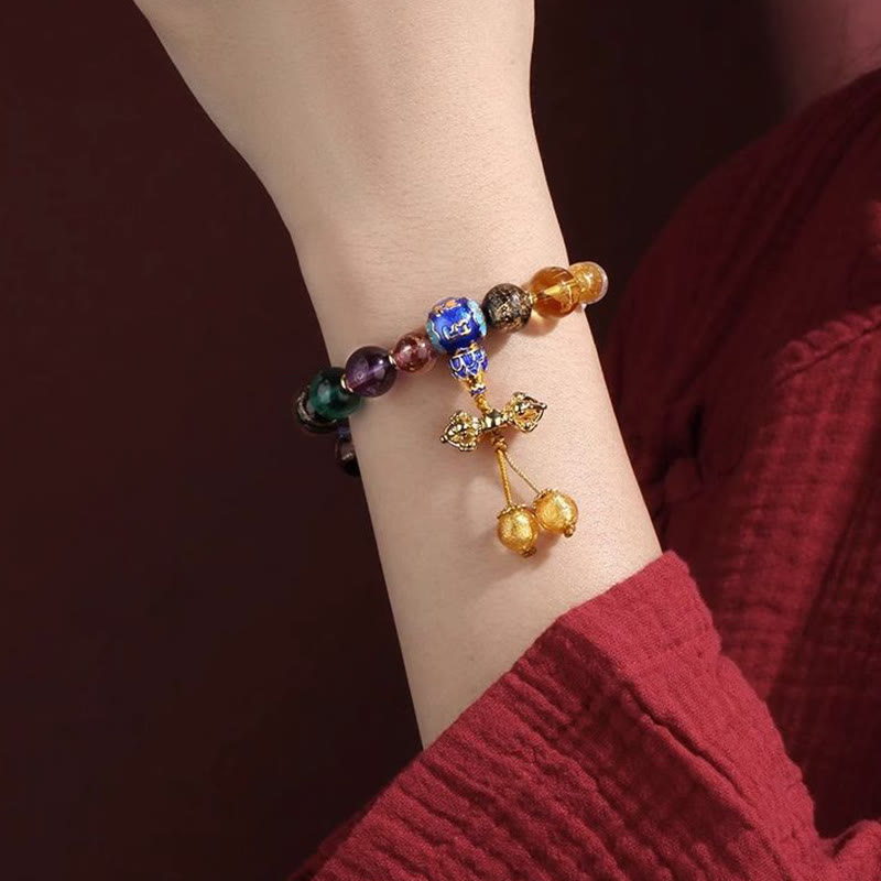 Tibetan Liuli Wrist Mala – Beaded bracelet worn on wrist with ornate gold bow charm and bell dangles