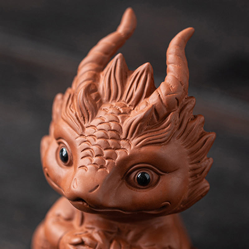 Luck Dragon Tea Pet - dragon held in hand showing scale, collectible purple clay art