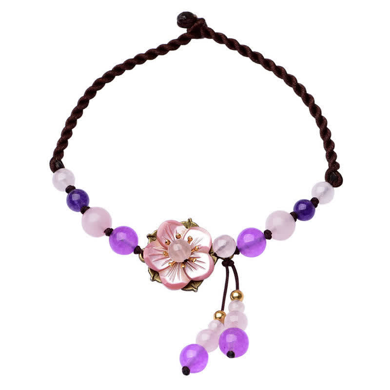 Amethyst Rose Quartz Crystal Charm Healing Anklet - Black stone yin-yang bracelet on wooden dish with red fabric, gold acc...