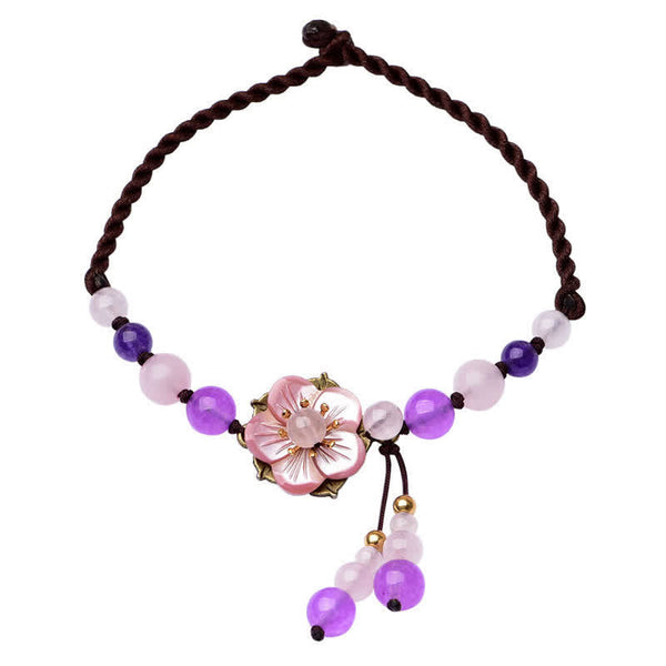 Amethyst Rose Quartz Crystal Charm Healing Anklet - Black stone yin-yang bracelet on wooden dish with red fabric, gold acc...