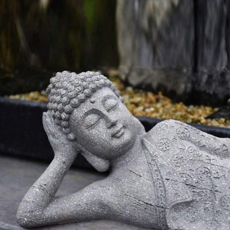 Tibetan Meditation Buddha Resin Decoration – macro of reclining Buddha face and hand detail, weathered stone look, garden blessing statue