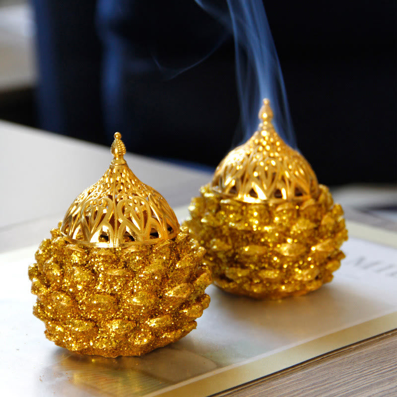 Gold Pine Cone Mini Incense Burner - Two burners on gold-rimmed tray with smoke, home ritual