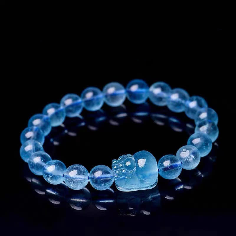 Natural Aquamarine PiXiu Serenity Bracelet – Translucent aquamarine bead bracelet with PiXiu charm on black, healing jewelry