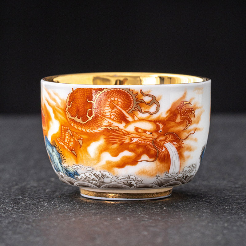 Dragon Phoenix Crane Gilt Ceramic Teacup – dynamic orange dragon motif with gold detailing and blue wave border on white porcelain, luxury