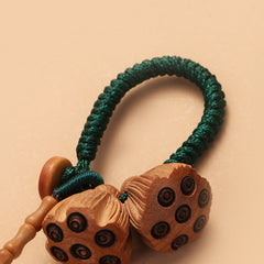 Bodhi Seed Peach Wood Lotus Keychain – Full-length hanging view showing white lotus bud, wooden pods and green loop on white background