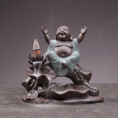 Little Monk Ceramic Incense Burner - Joyful monk with arms raised, backflow smoke over lotus petals, ceramic aromatherapy decor