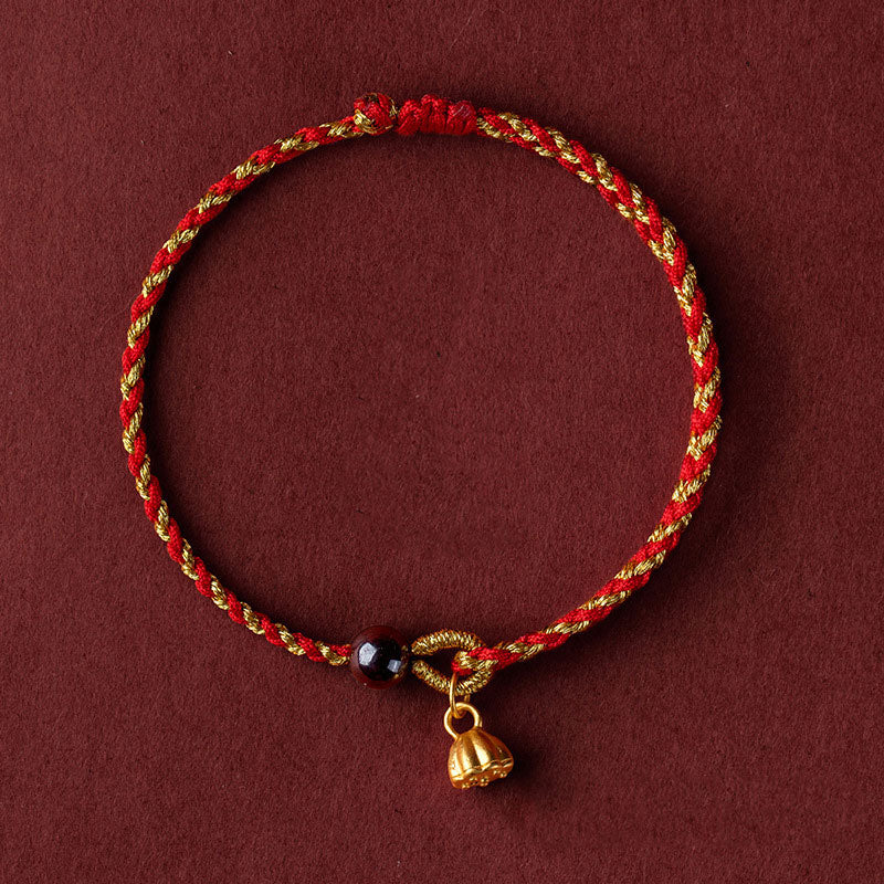 Red Gold Rope Lotus Braid Bracelet - centered flat lay on burgundy with lotus charm, braided jewelry