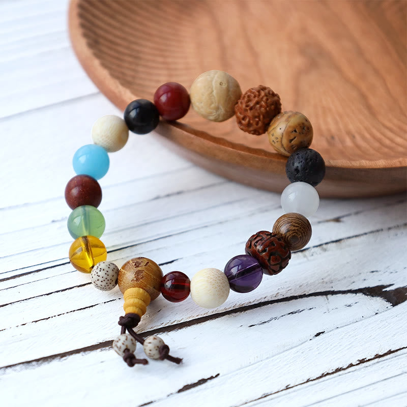 Tibetan Singing Bowl Gift Bundle – Multi-stone beaded mala bracelet on white wood, chakra beads