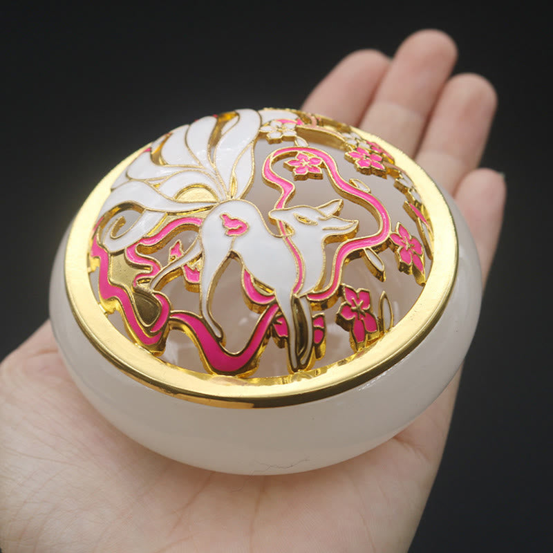 White Nine-Tailed Fox Liuli Burner - Held in hand showing fox and cherry blossom lid, incense holder