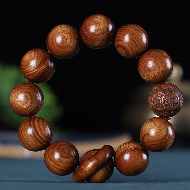Chinese Zodiac Wood Bracelet – amber sandalwood sphere beads with carved wealth blessing focal bead, dark studio
