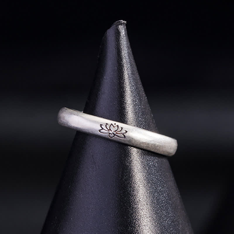 Lotus Enlightenment Ring - oxidized lotus engraving on black leather display cone, spiritual