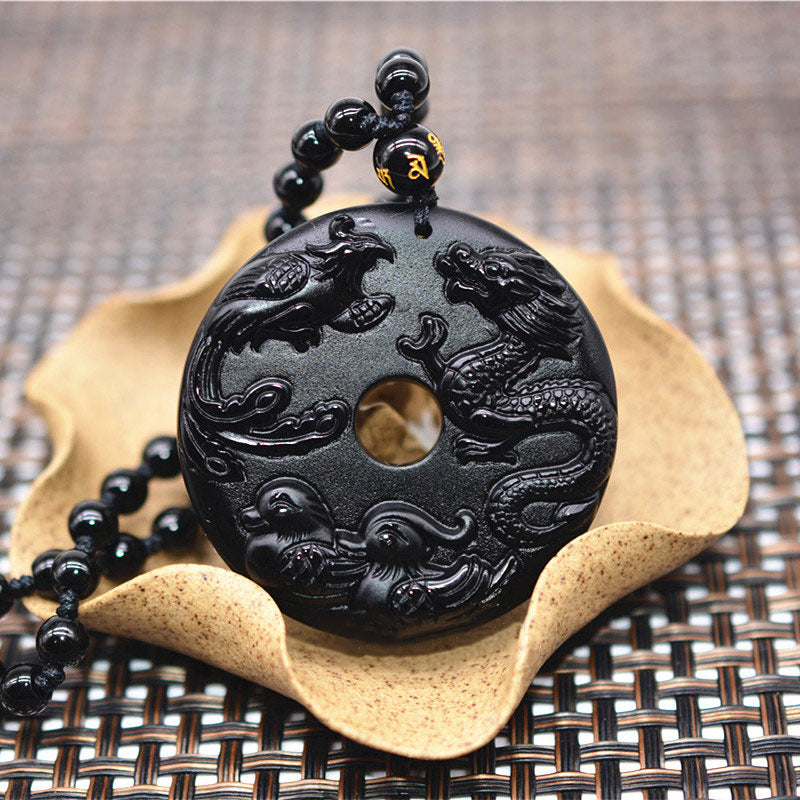 Black Obsidian Dragon Phoenix Pendant - Carved obsidian bi-disc resting on ceramic lotus dish with woven mat, Luck