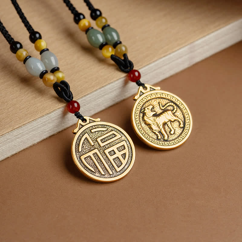 12 Chinese Zodiac Fortune Necklace Pendant – Two zodiac pendants displayed on wooden plank, fortune Fu character medallion and tiger medallion in antique gold, matching beaded cords with jade and carnelian, couple friendship blessing necklace set