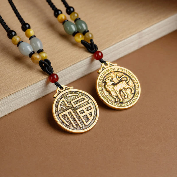 12 Chinese Zodiac Fortune Necklace Pendant – Two zodiac pendants displayed on wooden plank, fortune Fu character medallion and tiger medallion in antique gold, matching beaded cords with jade and carnelian, couple friendship blessing necklace set
