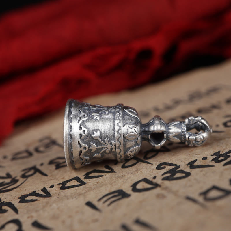 925 Silver Dorje Bell Pendant – Side profile of carved silver bell with lotus motifs on manuscript