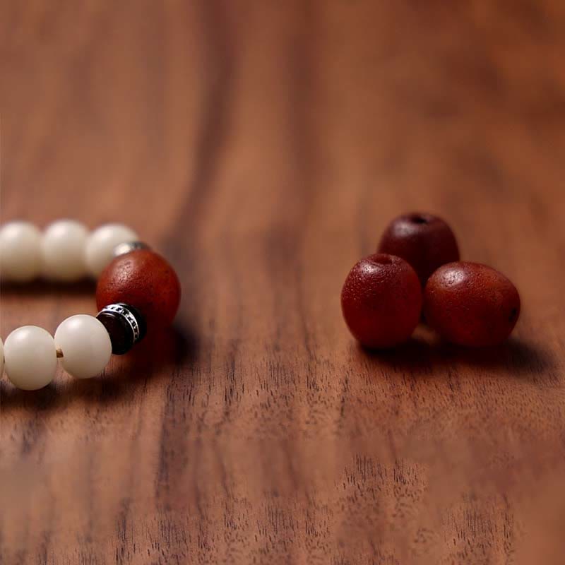 108 Mala Beads Bracelet – Macro of cream beads and rust agate accent
