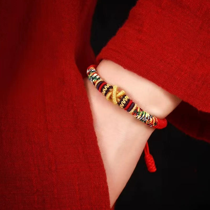 Tibetan Mantra Bracelet – Worn on wrist showing gold knot and multicolor macrame, red sleeve styling