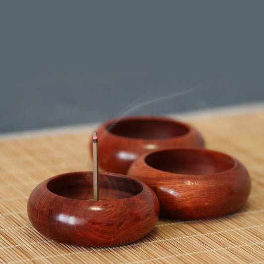 Rosewood Incense Burner – three polished bowls arranged on woven mat, front holder lit with rising smoke, calming