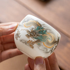 Dragon Phoenix Clouds Ceramic Teacup Gift Set – Gold and teal dragon amid clouds, hand-held on wood, artisan relief