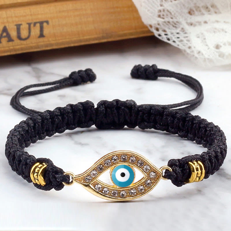 Black cord evil eye bracelet with gold turquoise evil eye crystal pave, marble lifestyle