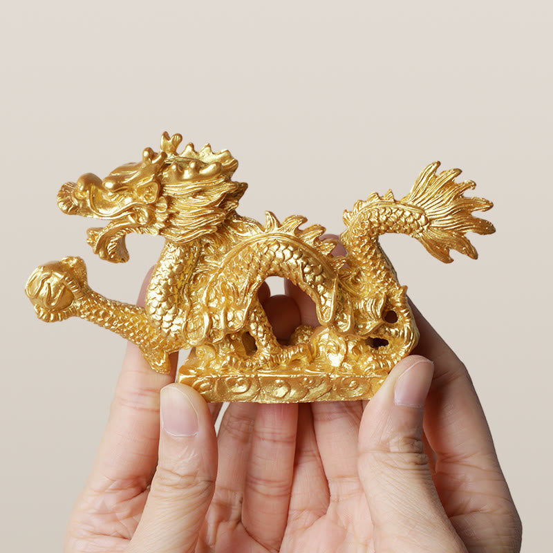 Feng Shui Dragon Statue - two hands displaying golden pearl dragon, detailed, meaningful