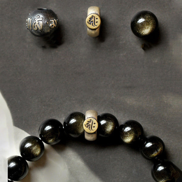 Zodiac Natal Buddha Obsidian Silver Bracelet - Flat lay with loose mantra beads on gray stone