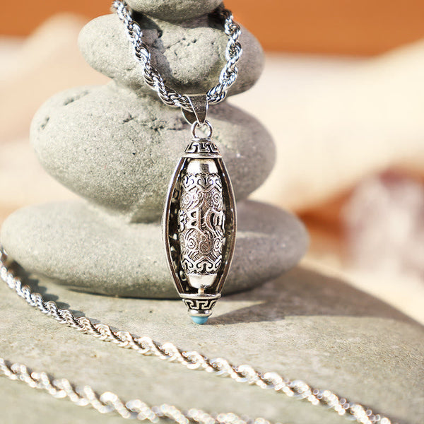 Tibetan Om Mani Padme Hum Pendant Necklace – oval pendant on stacked zen stones with warm bokeh, Buddhist jewelry