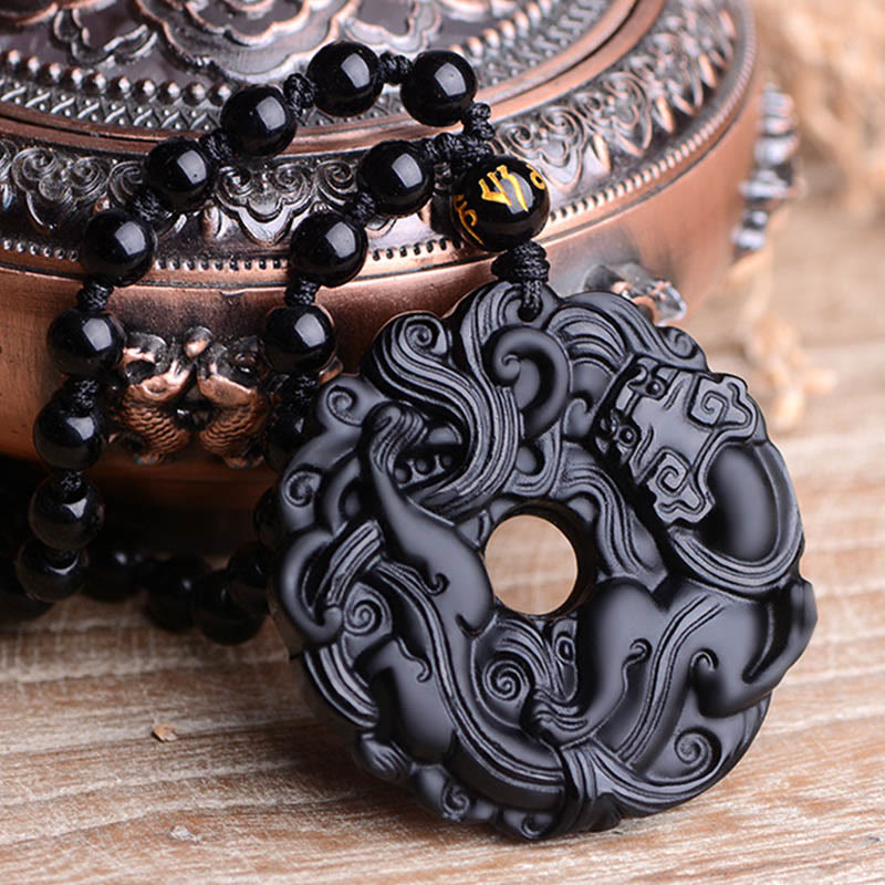 Black Obsidian Pixiu Pendant – Pendant displayed beside ornate bronze incense burner decor