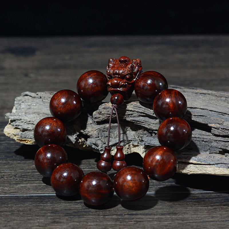 Multi-Wood Dragon Bracelet - Burgundy beads with carved lion head on weathered driftwood, Strength