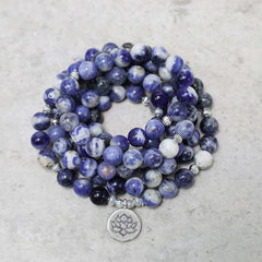 Blue Aventurine Lotus Peace Bracelet – coiled multi-strand beads with silver lotus charm on gray stone, natural gemstone wrap bracelet