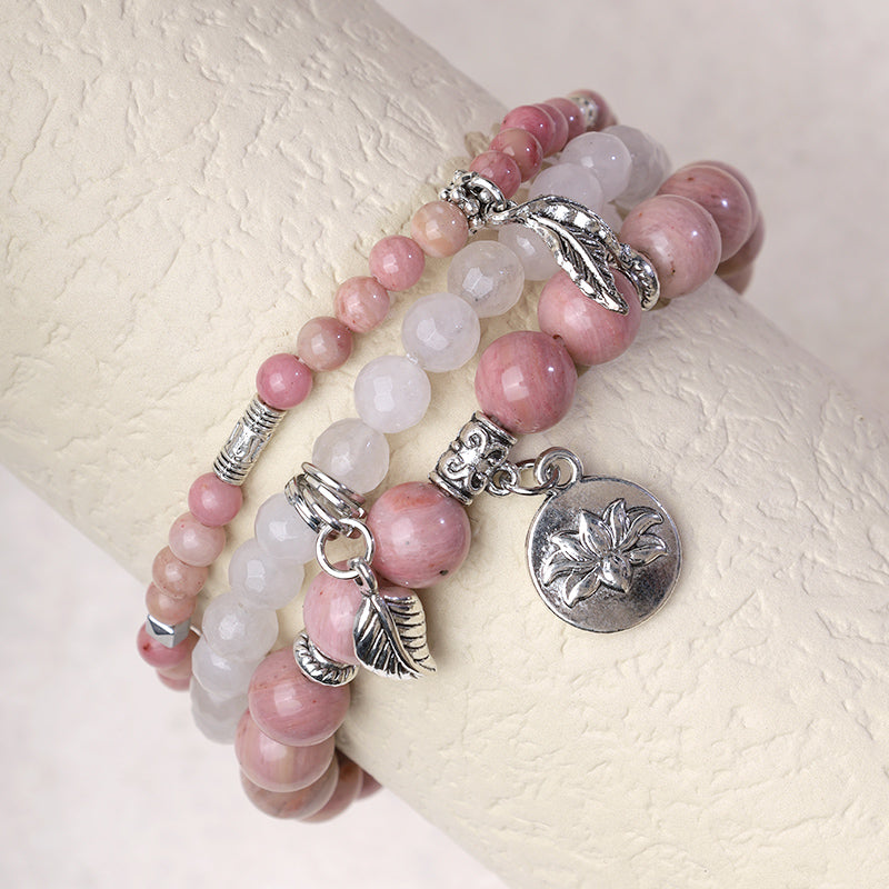 Crystal Lotus Bracelet – rose pink and white opalescent beads on wrist display with silver lotus charm, stacking bracelet