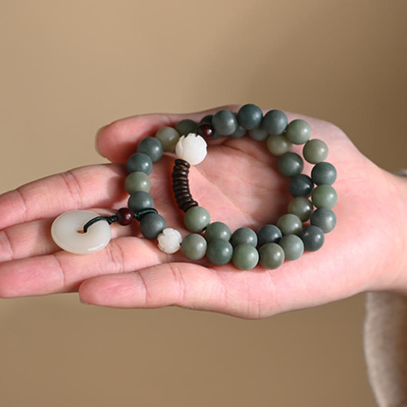 Cyan Bodhi Seed Jade Peace Buckle Bracelet - green bodhi seed beads resting in palm, mindful wellness