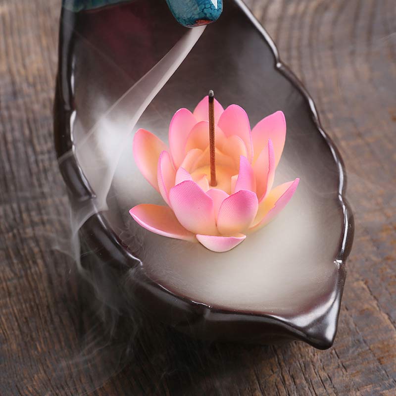 Little Deer Ceramic Lotus Incense Burner – Overhead view of pink lotus with backflow smoke pooling in dark ceramic tray