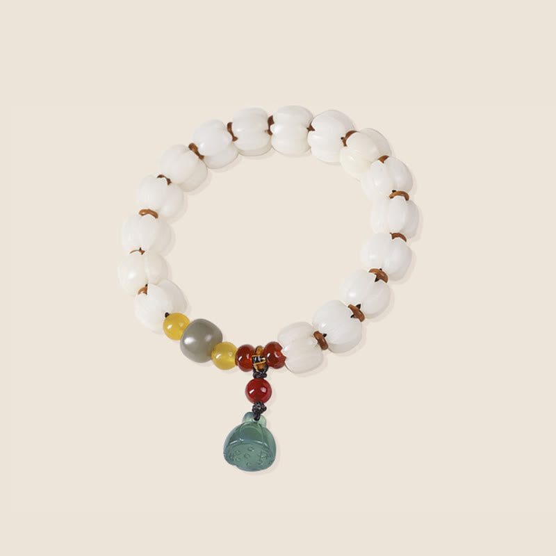 Bodhi Seed Lotus Bead Bracelet - overhead view, circular bead layout with jade pendant