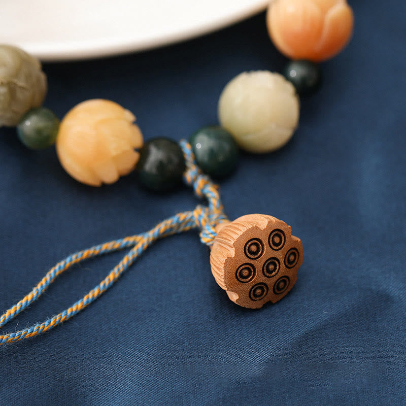 Bodhi Seed Moss Agate Lotus Peace Bracelet - lotus pod charm on navy fabric, spiritual