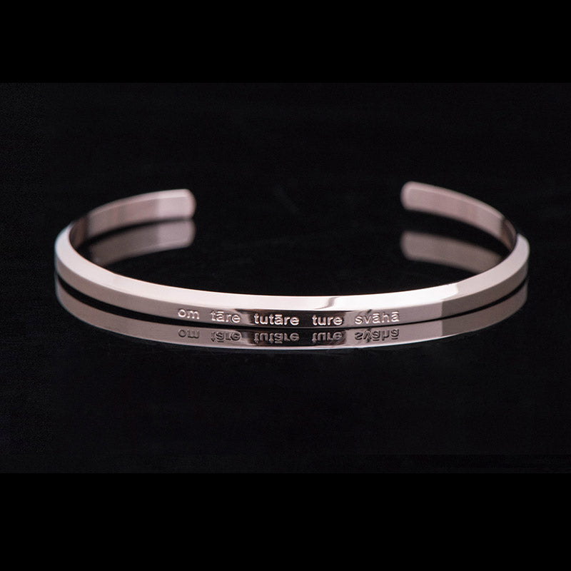Om Mani Padme Hum Engraved Bracelet – silver cuff with raised ridges and mantra text, minimalist bangle