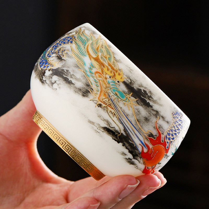 Dragon Playing Pearl Porcelain Teacup – Gold dragon with cobalt scales in ink-wash clouds, hand-held artisan craft