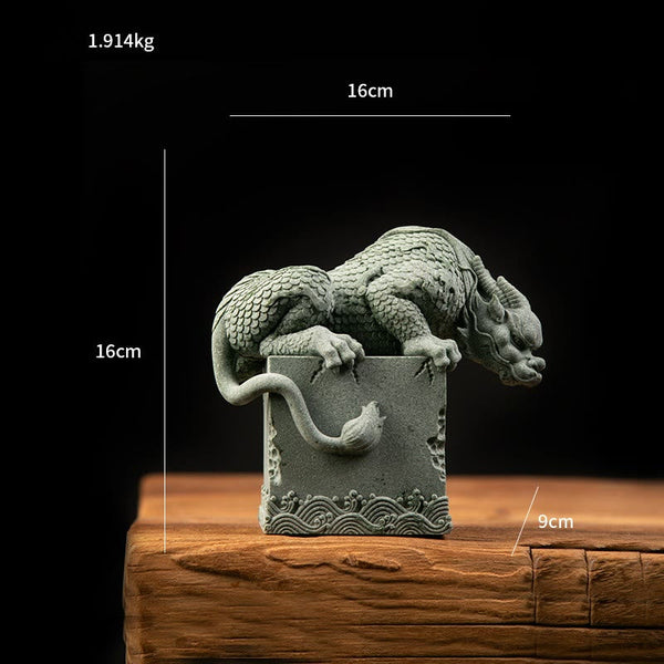 Feng Shui Dragon Sandstone Statue crouching dragon profile on stone, foliage backdrop, tranquil, natural